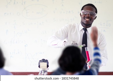 Science african teacher standing in front of blackboard teaching student in classroom