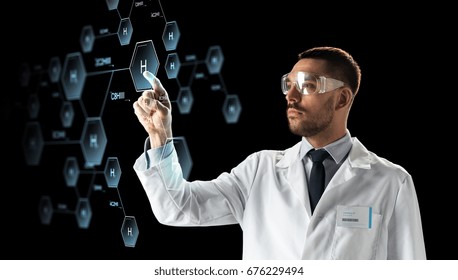 science, chemistry and people concept - male doctor or scientist in white coat and safety glasses touching virtual projection of chemical formula over black background - Powered by Shutterstock