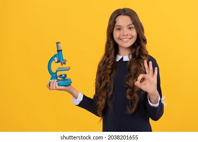 science and childhood. teen girl presenting microscope. back to school. study biology,