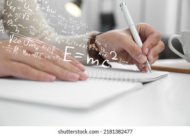 Science And Education Concept. Illustration Of Basic Physics And Mathematics Formulas And Woman Working At Table, Closeup