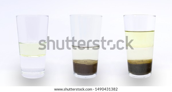 Science experiment: heterogeneous\
mixture of water, oil and sand; water and oil; water and\
sand.