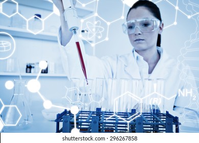 Science graphic against pretty female biologist holding a manual pipette with sample from test tubes