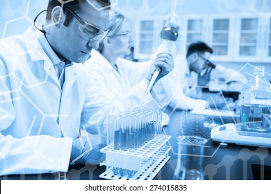 Science graphic against science student using pipette in the lab to fill test tubes - Shutterstock ID 274015835