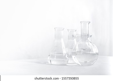 Science laboratory chemical beaker, Erlenmeyer and round flask lab glassware equipment. Research and development concept. - Shutterstock ID 1557350855