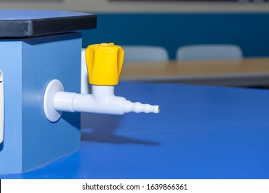 Science Laboratory Gas Nozzle On A Blue Empty School Lab Table In An Educational Setting For Experiements, Analysis And Research