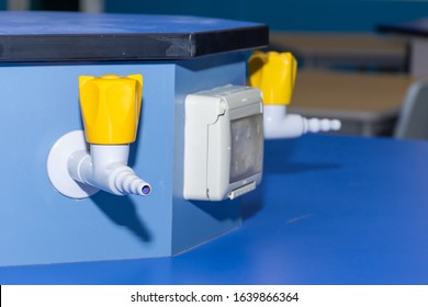 Science Laboratory Gas Nozzle On A Blue Empty School Lab Table In An Educational Setting For Experiements, Analysis And Research