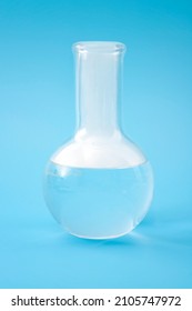 Science Laboratory, Scientific Experiment And Lab Test Concept With Dry Ice In A Glass Chemistry Beaker Isolated On Blue Background