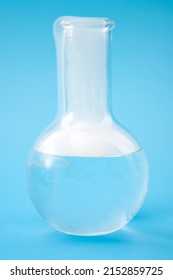 Science Laboratory, Scientific Experiment And Lab Test Concept With Dry Ice In A Glass Chemistry Beaker Isolated On Blue Background