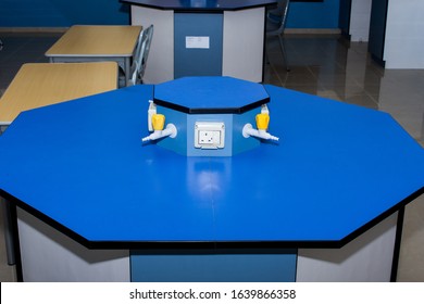 Science Laboratory Table Of Gas Nozzles And Electricity On A Blue Empty School Lab Table In An Educational Setting For Experiements, Analysis And Research