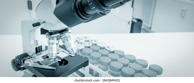 Science Microscope On Lab Bench. Microbiology Laboratory. Blue Toned Image Of Binocular Microscope. Water Sampling Procedure For Microbiological Analysis