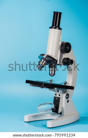 science microscope on light blue background