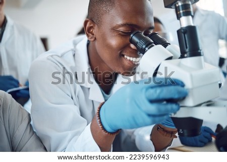 Science, microscope and students learning in class, classroom physics and happy with research in a lab. Innovation, scientist and African teenager in high school studying microbiology for education