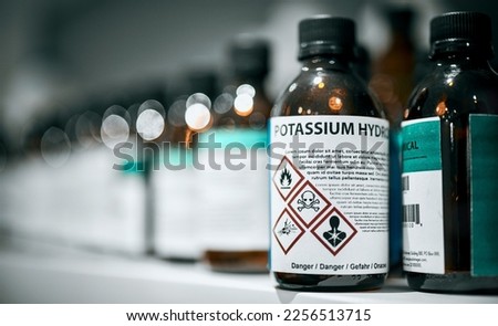 Science, pharmaceutical chemical and bottle on shelf in laboratory for medical research. Healthcare, medicine and innovation in manufacturing of poison antidote with danger on warning label in lab.