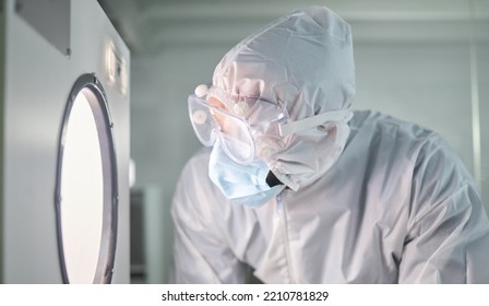 Science, Research And Laboratory In Ppe Working Dangerous Material, Virus Or Disease. Scientist, Lab And Clothes For Safety Focus While At Work For Analysis Of Bacteria, Chemical Or Radioactive Test