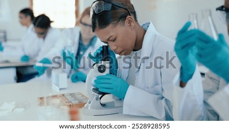 Science, student and analysis with microscope in classroom for sample study, practical lesson and education. High school girl, examine and learning of medical research for experiment with ppe safety