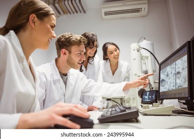 Science Students Looking At Microscopic Image On Computer At The University