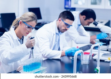 Science Students Working With Chemicals In Lab At The University