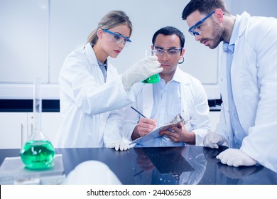 Science students working together in the lab at the university - Shutterstock ID 244065628