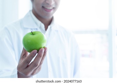 Science Teacher Shows Green Apple Received From Student, Apple In Hand, Selective Focus