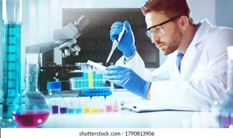 Science technician using a pipette with a microtiter plate and a petri dish while working in the laboratory