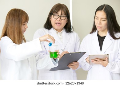 Sciene Test. Chemist scientific testing quality. Group Scientist working at laboratory. One Man and Three woman at chemistry lab. Asian people.