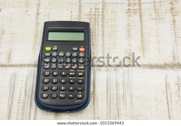 Scientific Calculator on\
wooden background