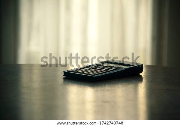 scientific\
calculator on wooden table in\
office