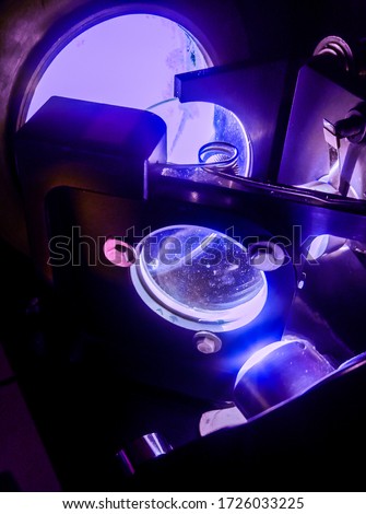 Scientific experiment during a physics class of a a lycee of the French higher education : mirrors and precision lenses of a Michelson interferometer in a laboratory of wave optics used in blue light