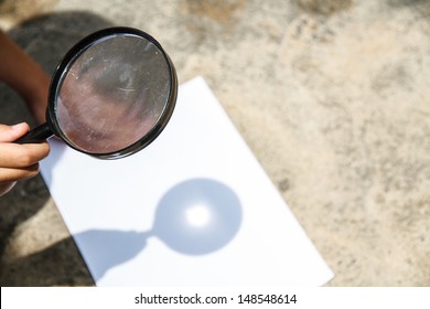 Scientific Experiments. Use A Magnifying Glass To Light The White Paper.