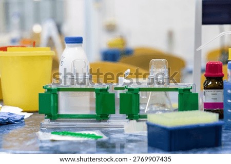 Scientific instruments on a laboratory bench, two holders ready for forming acrylamide gels for electrophoresis.