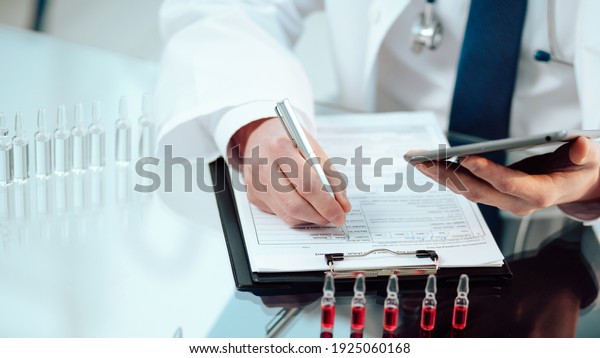 scientific laboratory assistant recording the\
results of a vaccine\
study.