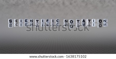 scientific notation concept represented by wooden letter tiles