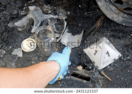 The Scientific Police, CSI, Collecting samples of charred remains burned in an arson of vehicles