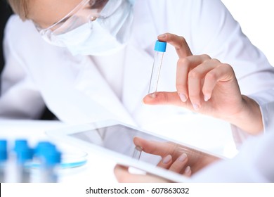 Scientific Research Team With Clear Solution In Laboratory, Close Up