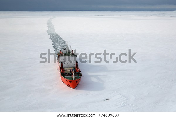 Scientific research vessel, breaks its way in\
the ice of the Antarctic. View from\
above.