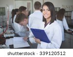 Scientific researcher holding a folder of chemical experiment research.Science students working with chemicals in the lab at the university.Happy student, content for experimental results.Pharmacy
