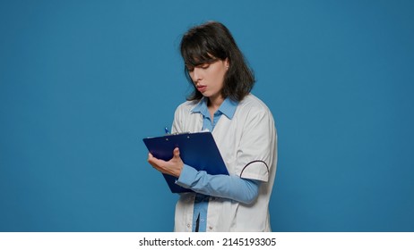 Scientific Researcher Taking Experiment Notes On Papers In Studio, Working On Biotechnology And Biochemistry Development. Biology Scientist Writing Genetic Research Discovery On Files.