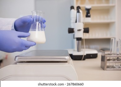 Scientific Weighing White Liquid In Beaker In The Laboratory