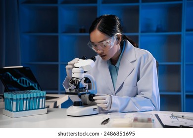 Scientist adjusting microscope, conducting research in a modern laboratory. The lab is equipped with advanced technology, reflecting the cutting edge nature of her work - Powered by Shutterstock