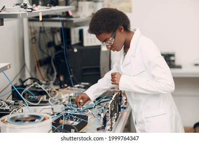 Scientist african american black woman working in laboratory and single photon decoder encoder fiber optic cryptography.