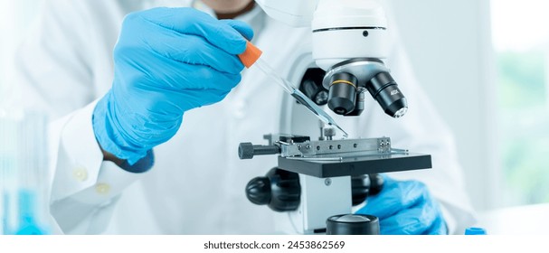 Scientist analyze biochemical samples in advanced scientific laboratory. Medical professional use dropper mix microbiological developmental of viral. Biotechnology research in  science lab. cosmetic - Powered by Shutterstock