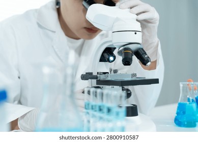 Scientist analyze biochemical samples in advanced scientific laboratory. Medical professional use microscope look microbiological developmental of viral. Biotechnology research in science lab.