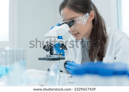 Scientist analyze biochemical samples in advanced scientific laboratory. Medical professional use microscope look microbiological developmental of viral. Biotechnology research in science lab.