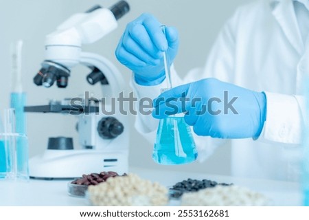 Scientist analyze biochemical samples in advanced scientific laboratory. Medical are mixing chemicals to test physical properties of cosmetic. develop viral. Biotechnology research in science lab.