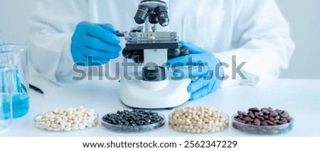 Scientist analyze biochemical samples in advanced scientific laboratory. Medical professional use microscope look microbiological developmental of viral. Biotechnology research in science lab.