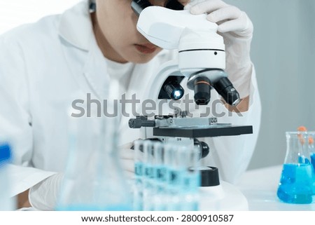 Scientist analyze biochemical samples in advanced scientific laboratory. Medical professional use microscope look microbiological developmental of viral. Biotechnology research in science lab.