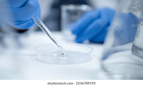 Scientist analyzing and dropping a sample into a glassware, experiments containing chemical liquid in laboratory on glassware - Powered by Shutterstock