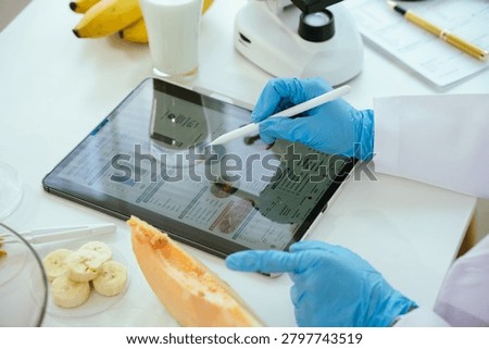 Scientist analyzing a fruit sample under a microscope in a food safety laboratory, performing quality control, nutritional assessment, and contamination testing of fresh produce.