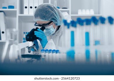 Scientist Analyzing Samples Under Microscope in Modern Laboratory Environment