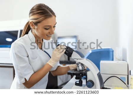 Scientist biochemist or microbiologist working research with a microscope in laboratory. ストックフォト © 